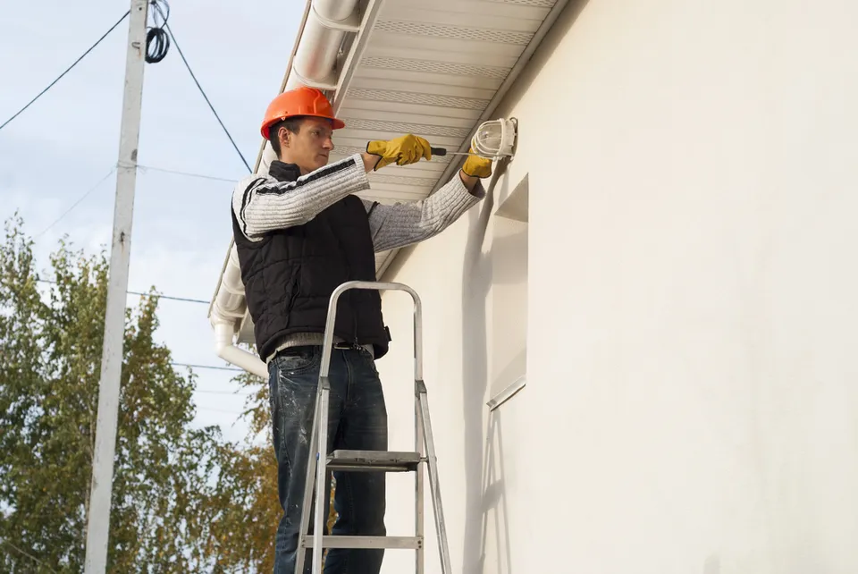 Electrician near me installing outdoor motion lighting