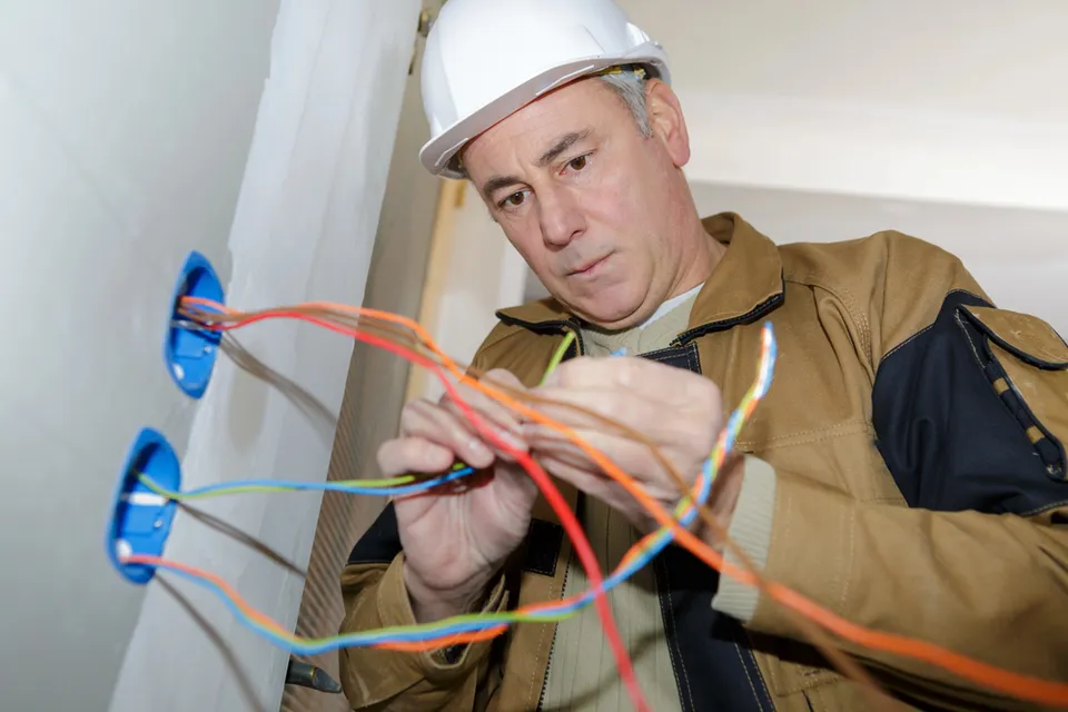 Electrician performing rewiring and knob and tube replacement in Rhode island home